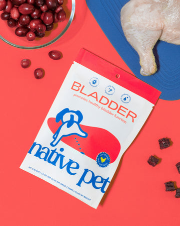  bladder chews packaging with cranberries and chicken in front of a red background.