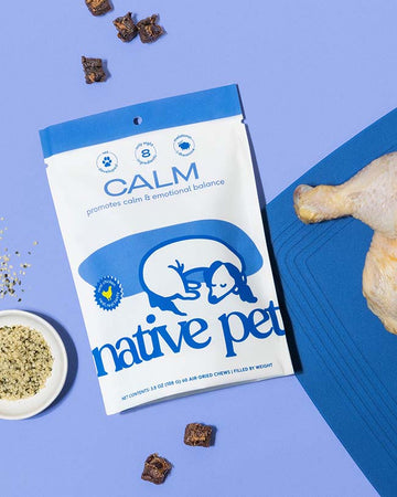 Native Pet Calm Chews on a purple background with a raw chicken thigh on the right and chews sprink